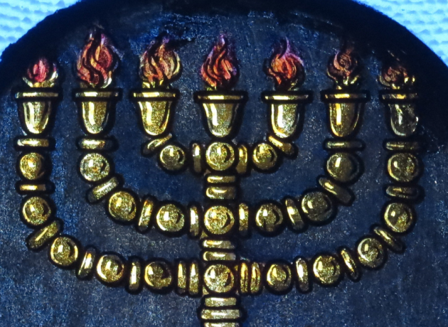 Den syvarmede stage, Menorah, mistede sin plads og betydning i jødedommen ved templets ødelæggelse i år 70 e.Kr. I kristendommen fik stagen en ny symbolsk betydning og en opblomstring i Danmark i 1900-tallet på grundt af Grundtvig, skriver domprovst Poul-Henning Bartholin. Billedet er et glasmaleri af en menora, fra "Immaculate Conception Catholic Church" i Knoxville, Tennessee